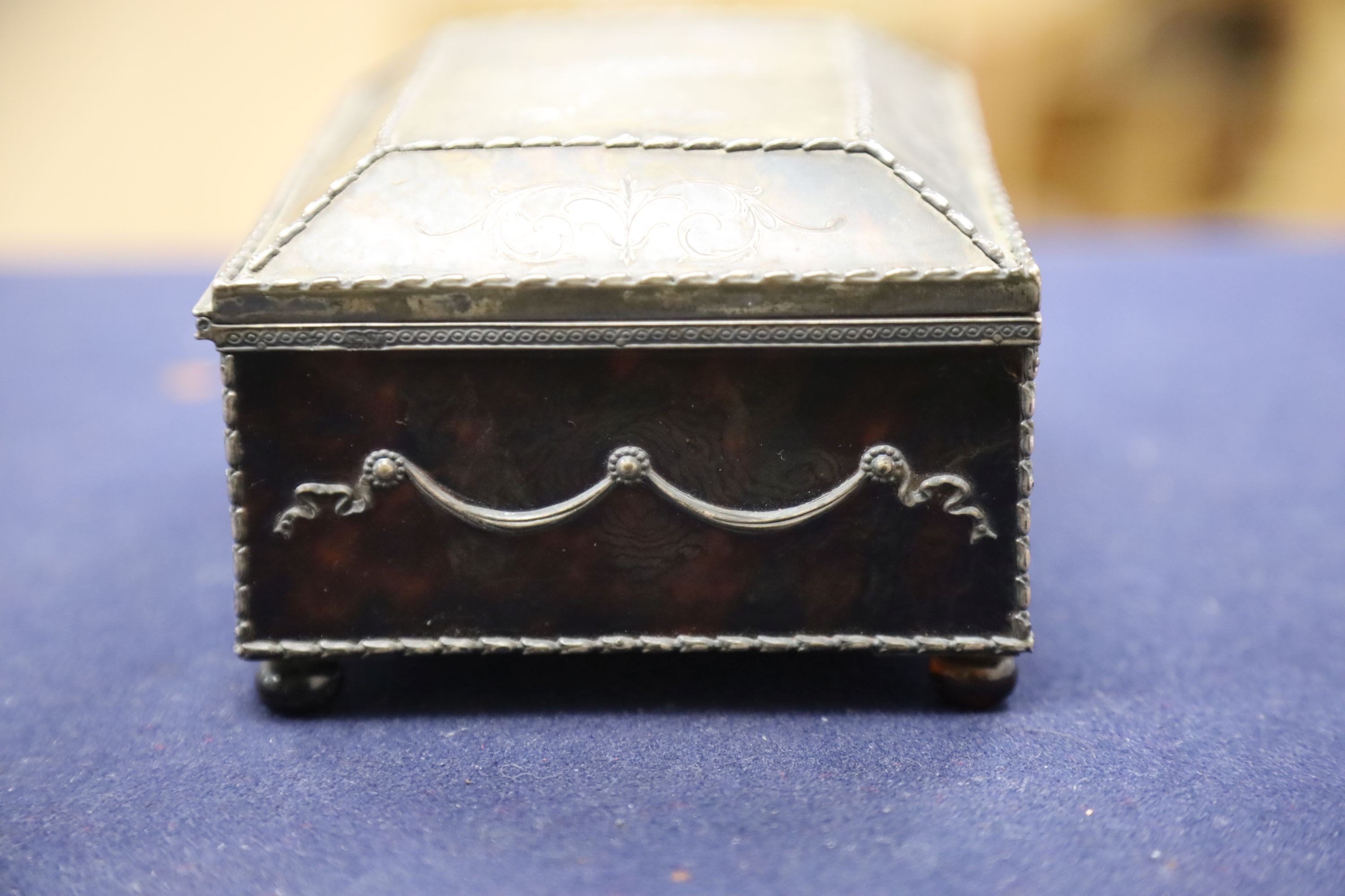 A silver-mounted tortoiseshell pique rectangular trinket box, by William Comyns, raised on four ball feet, London, 1904, width 15cm. 15cm